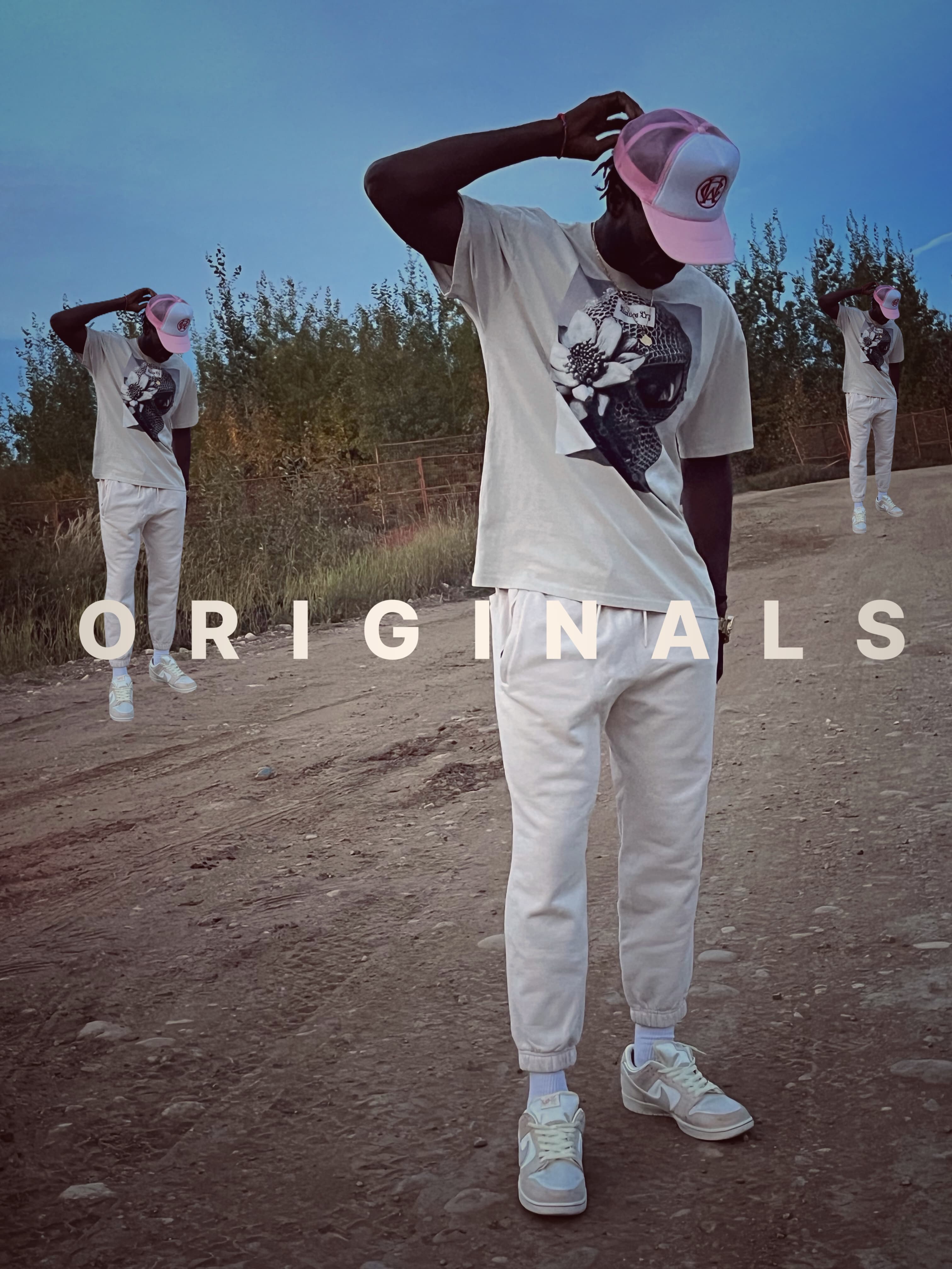 Model wearing the oversized balaclava tee in bone white, paired with casual white joggers and a pink Wolves Cry cap, showcasing the tee’s streetwear versatility.