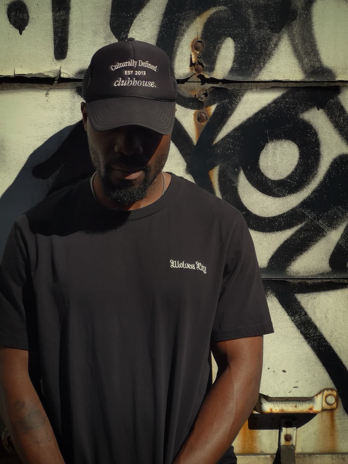 Model wearing the Wolves Cry Embroidered Organic Tee in black. A clean, versatile streetwear look that blends minimalism with eco-conscious craftsmanship.