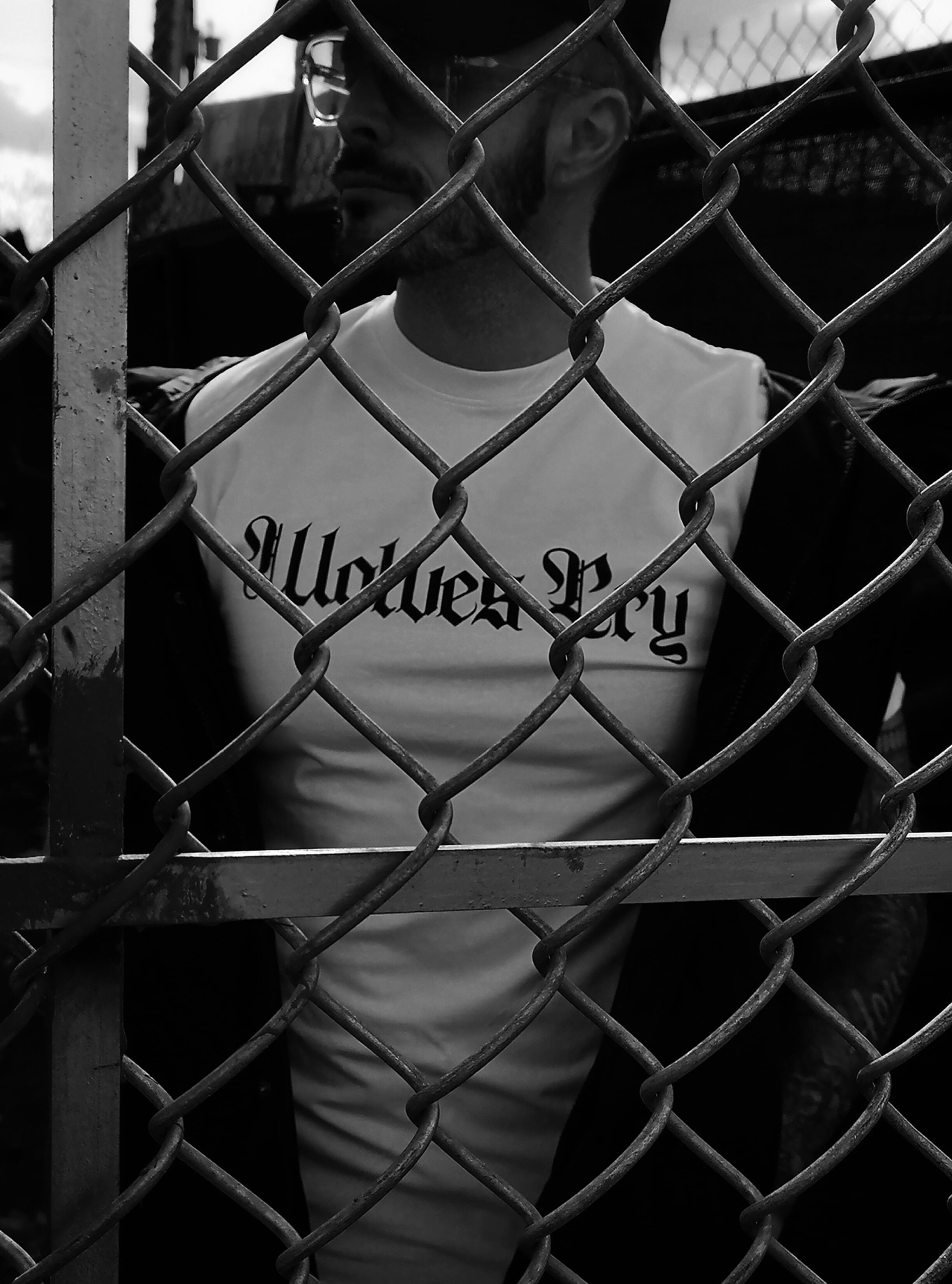 Detailed shot of the Wolves Cry Spell-Out Tee in White, highlighting the premium cotton texture, bold chest branding, and clean finishing.